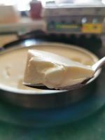 Thick yoghurt on a silver spoon Thick yoghurt on a silver spoon